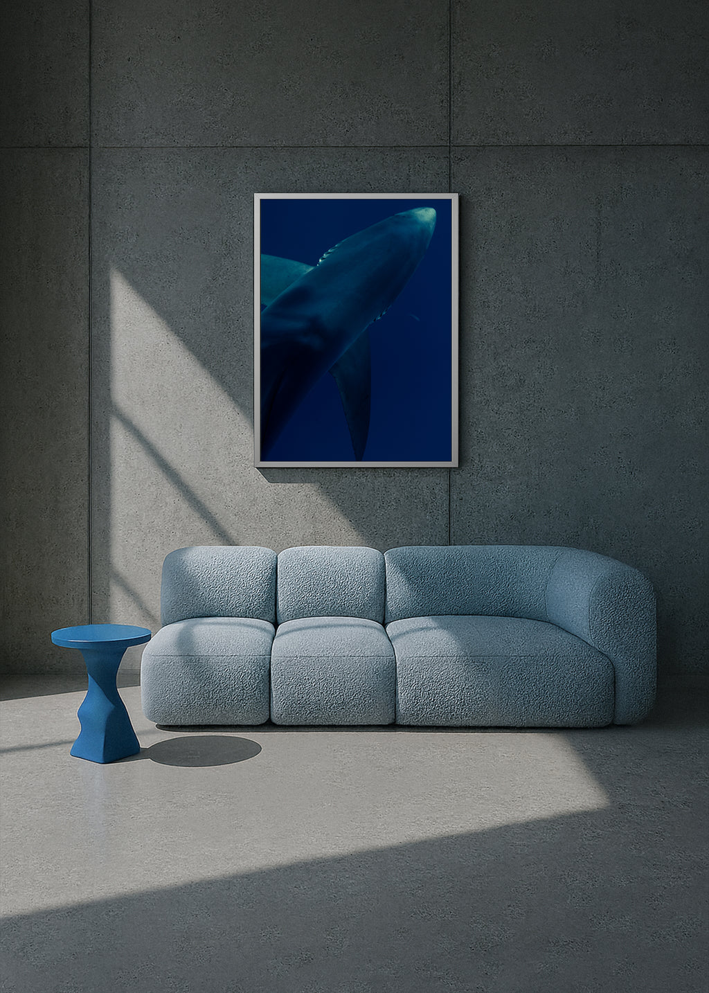 Modern interior with a blue sofa, small table, and framed artwork of a whale on a gray wall. underwater blue shark portrait – shark textures II – azores 2022 – her sky visual series