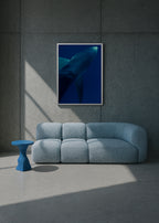Modern interior with a blue sofa, small table, and framed artwork of a whale on a gray wall. underwater blue shark portrait – shark textures II – azores 2022 – her sky visual series